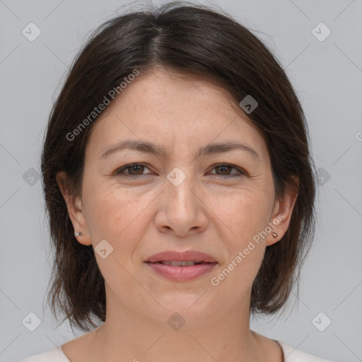 Joyful white adult female with medium  brown hair and brown eyes