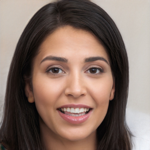 Joyful white young-adult female with long  brown hair and brown eyes