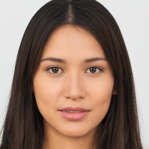 Joyful asian young-adult female with long  brown hair and brown eyes