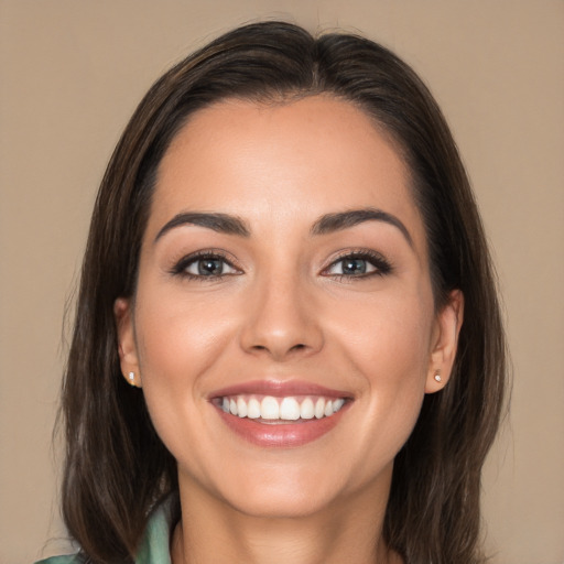 Joyful white young-adult female with long  brown hair and brown eyes