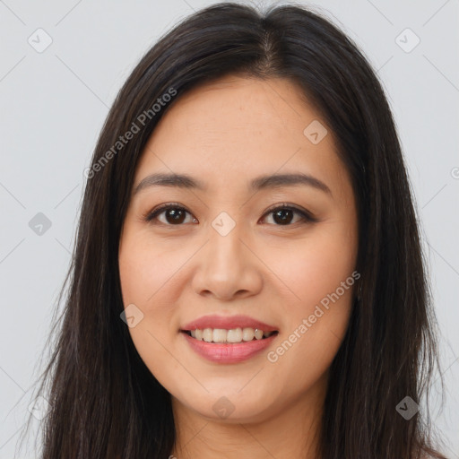 Joyful asian young-adult female with long  brown hair and brown eyes