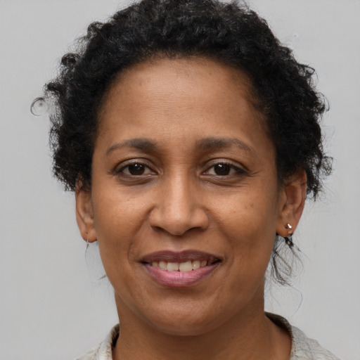 Joyful black adult female with short  brown hair and brown eyes