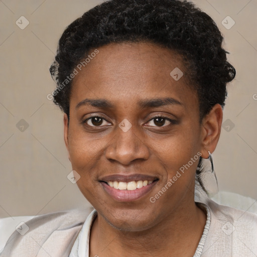 Joyful black young-adult female with short  black hair and brown eyes