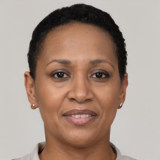 Joyful latino adult female with short  brown hair and brown eyes