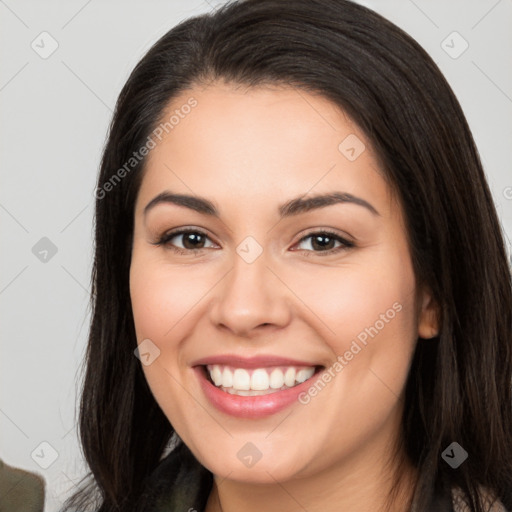 Joyful white young-adult female with long  brown hair and brown eyes