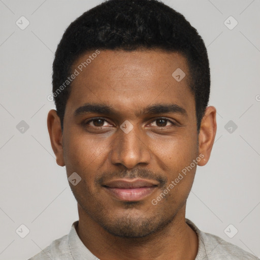 Joyful black young-adult male with short  black hair and brown eyes