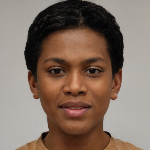 Joyful black young-adult female with short  black hair and brown eyes