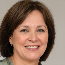 Joyful white adult female with medium  brown hair and brown eyes