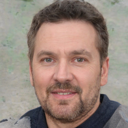 Joyful white adult male with short  brown hair and grey eyes