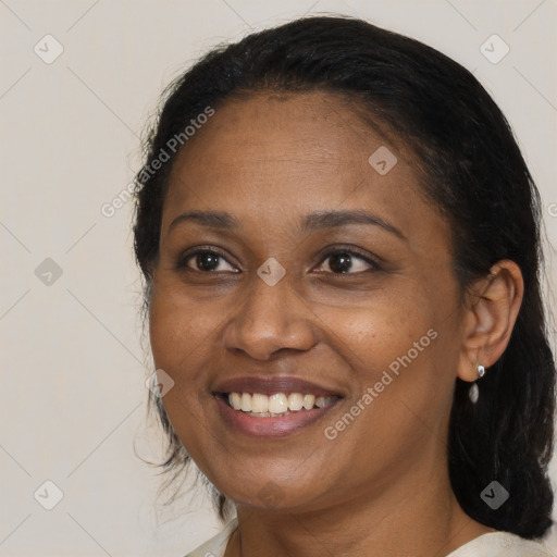 Joyful black adult female with medium  brown hair and brown eyes