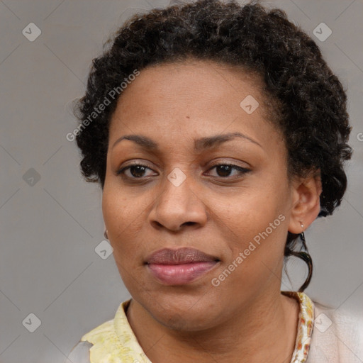 Joyful black adult female with short  brown hair and brown eyes