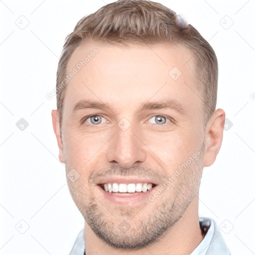 Joyful white young-adult male with short  brown hair and grey eyes