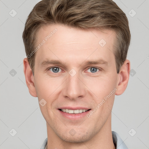 Joyful white young-adult male with short  brown hair and grey eyes