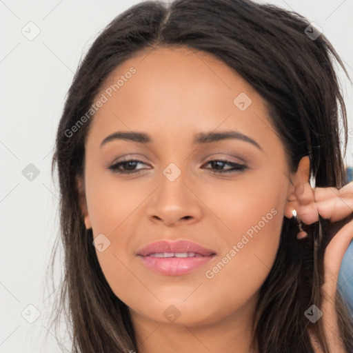 Joyful latino young-adult female with long  brown hair and brown eyes