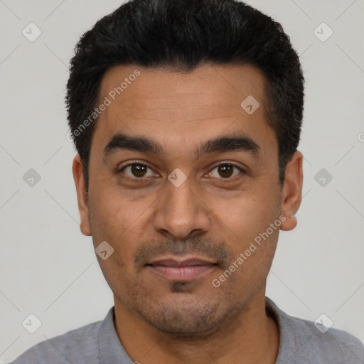 Joyful latino young-adult male with short  black hair and brown eyes