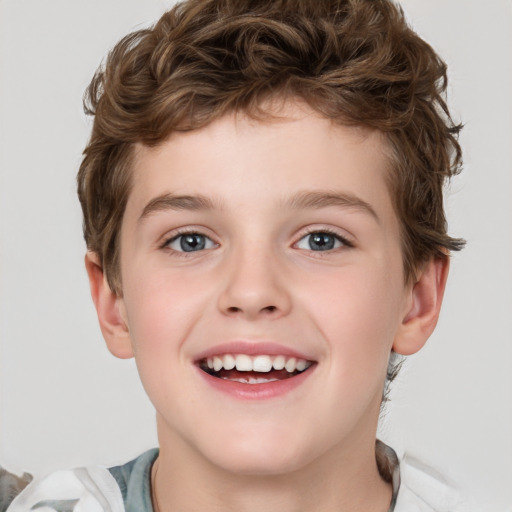 Joyful white child male with short  brown hair and grey eyes