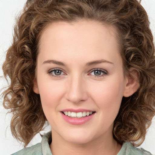 Joyful white young-adult female with medium  brown hair and green eyes