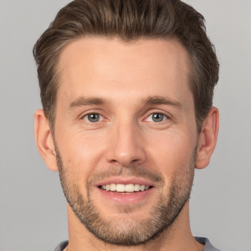 Joyful white young-adult male with short  brown hair and brown eyes