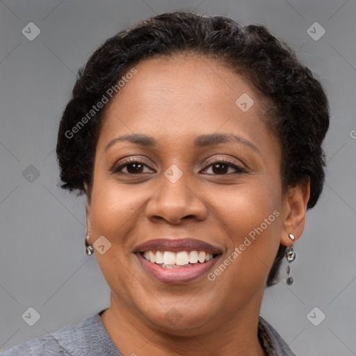 Joyful black adult female with short  brown hair and brown eyes