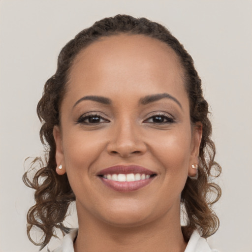 Joyful white young-adult female with long  brown hair and brown eyes