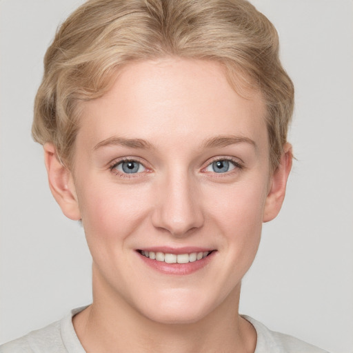 Joyful white young-adult female with short  brown hair and blue eyes