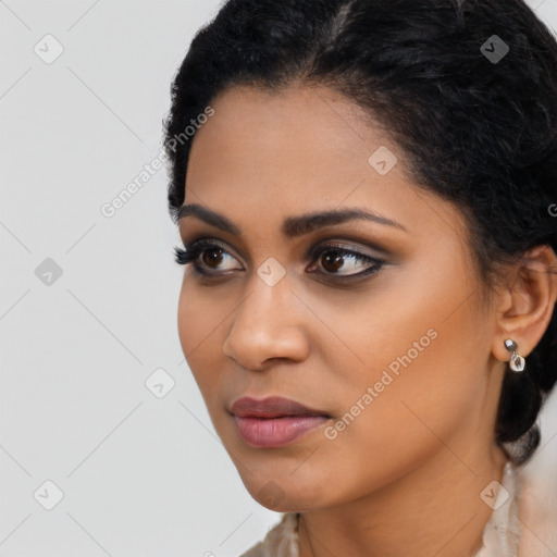 Joyful latino young-adult female with long  black hair and brown eyes