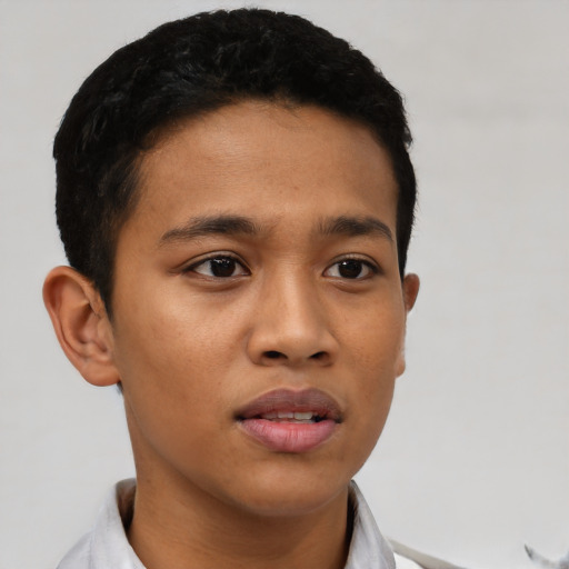 Joyful latino young-adult male with short  brown hair and brown eyes