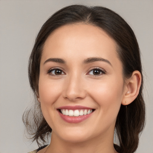 Joyful white young-adult female with medium  brown hair and brown eyes