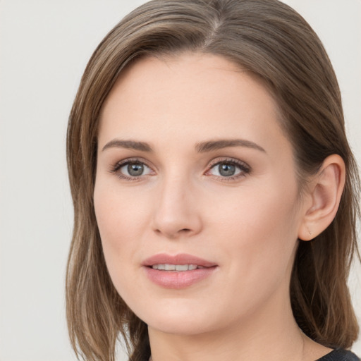 Joyful white young-adult female with medium  brown hair and grey eyes