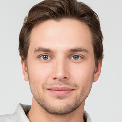 Joyful white young-adult male with short  brown hair and brown eyes