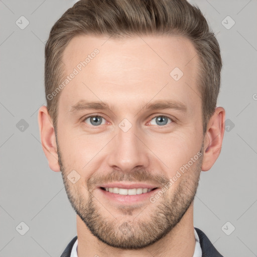 Joyful white young-adult male with short  brown hair and grey eyes