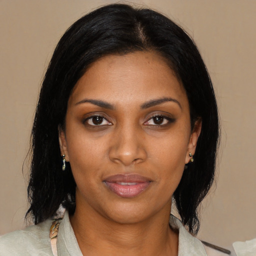 Joyful black young-adult female with medium  black hair and brown eyes