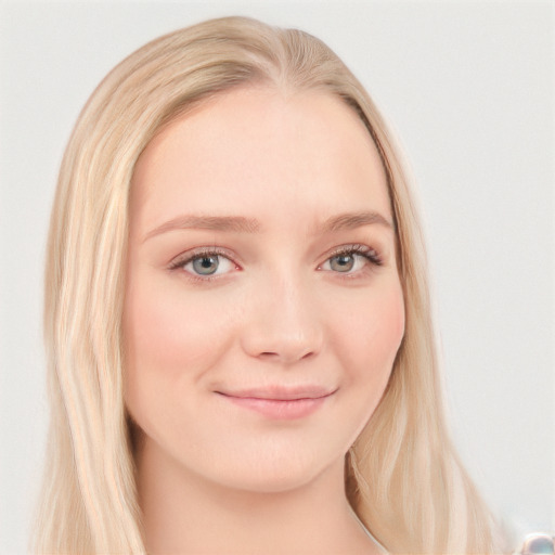 Joyful white young-adult female with long  blond hair and blue eyes