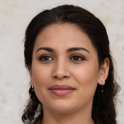 Joyful latino young-adult female with medium  brown hair and brown eyes