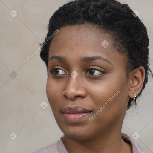 Joyful black young-adult female with short  black hair and brown eyes