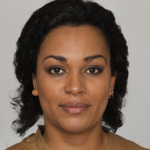 Joyful black young-adult female with medium  brown hair and brown eyes