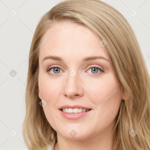 Joyful white young-adult female with long  brown hair and blue eyes