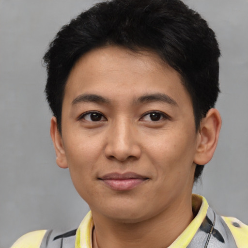 Joyful latino young-adult male with short  brown hair and brown eyes