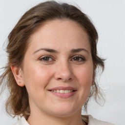 Joyful white young-adult female with medium  brown hair and grey eyes