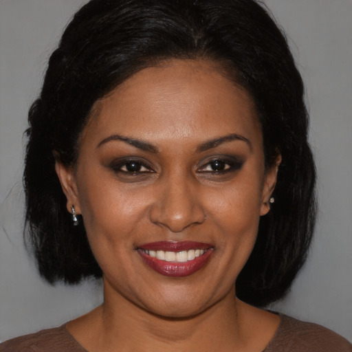 Joyful black young-adult female with medium  brown hair and brown eyes