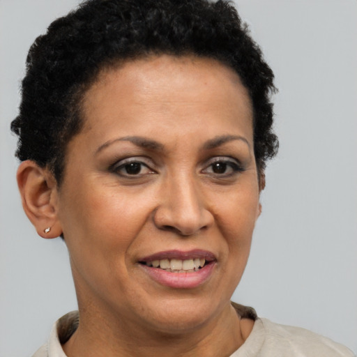 Joyful latino adult female with short  brown hair and brown eyes