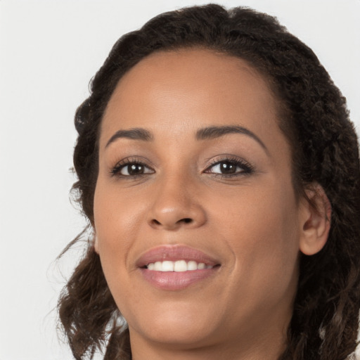 Joyful latino young-adult female with long  brown hair and brown eyes