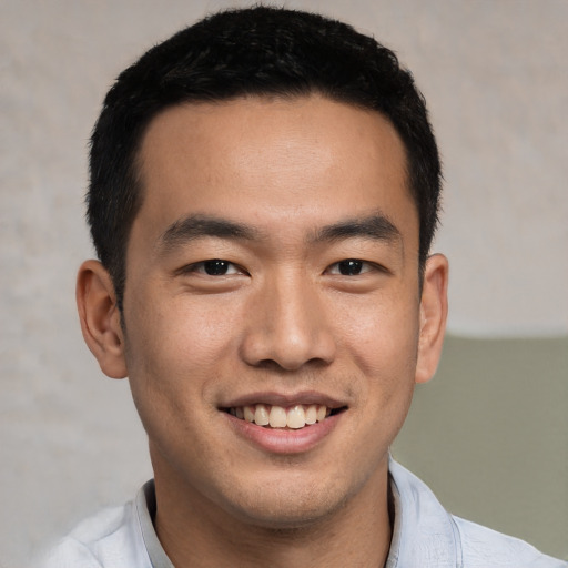 Joyful asian young-adult male with short  black hair and brown eyes