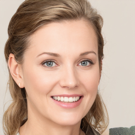 Joyful white young-adult female with medium  brown hair and blue eyes