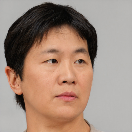Neutral asian adult male with short  brown hair and brown eyes