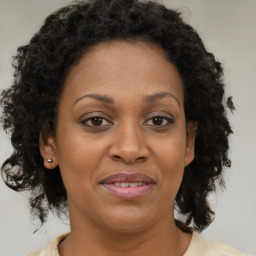 Joyful black adult female with medium  brown hair and brown eyes