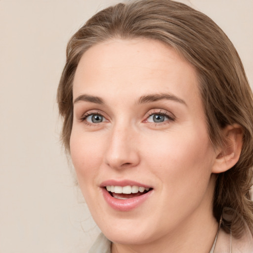 Joyful white young-adult female with medium  brown hair and blue eyes