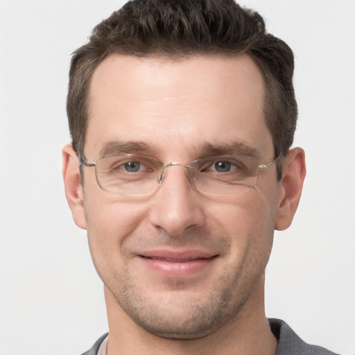 Joyful white adult male with short  brown hair and grey eyes