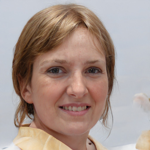 Joyful white adult female with medium  brown hair and grey eyes