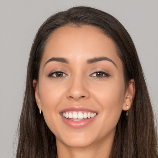 Joyful white young-adult female with long  brown hair and brown eyes